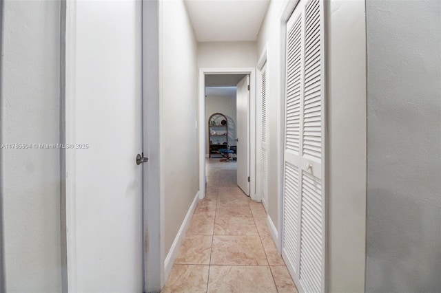 hall featuring baseboards