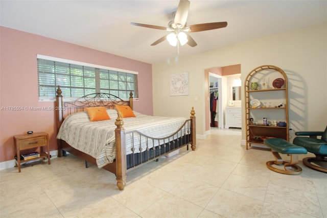 bedroom with a spacious closet, a ceiling fan, and light tile patterned floors