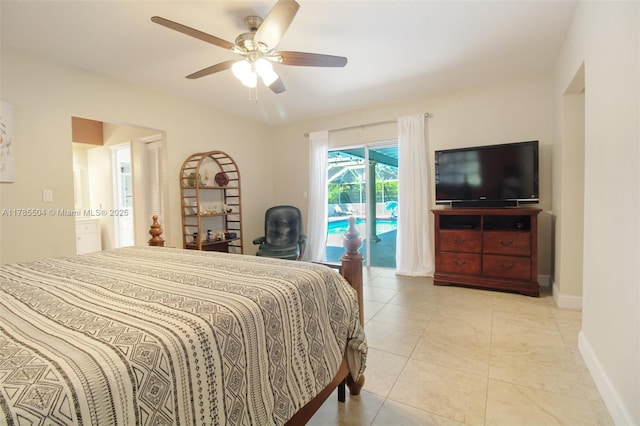 bedroom featuring a ceiling fan, light tile patterned flooring, ensuite bath, baseboards, and access to outside