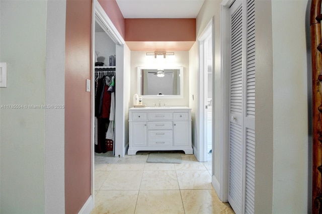 hallway with baseboards and a sink