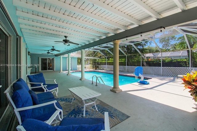 view of pool with glass enclosure, a fenced in pool, fence, a ceiling fan, and a patio