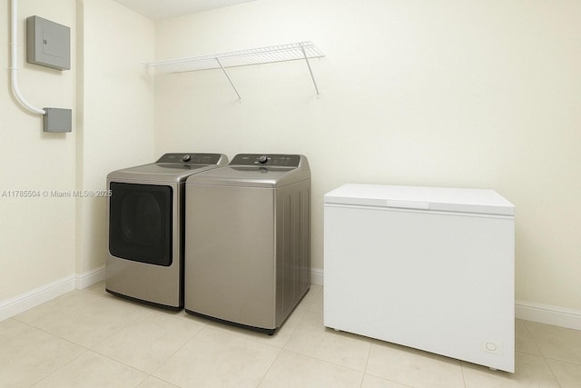 laundry area featuring light tile patterned floors, baseboards, laundry area, and independent washer and dryer