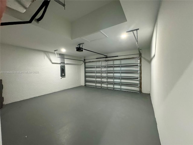 garage featuring a garage door opener and electric panel
