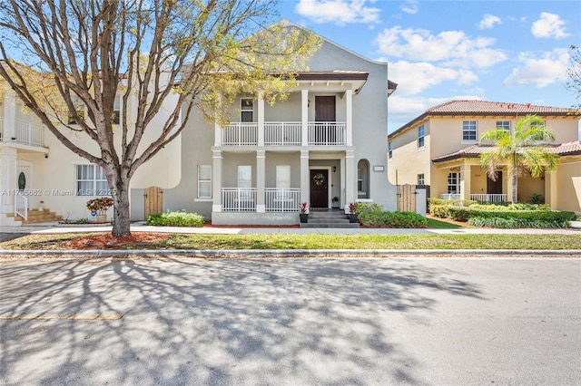 11640 SW 243rd St, Homestead, FL 33032 - greek revival inspired property with stucco siding, a balcony, and covered porch