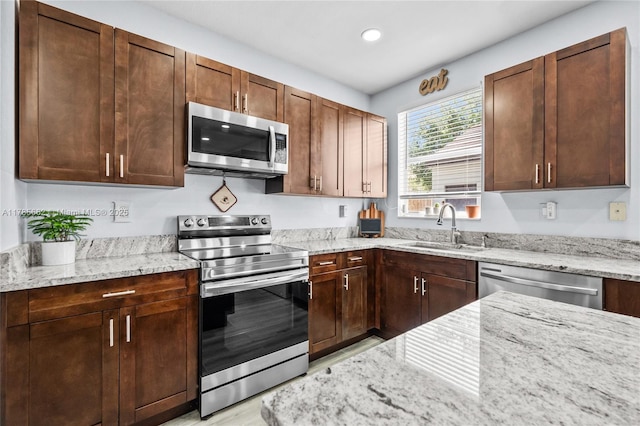 11640 SW 243rd St, Homestead, FL 33032 - kitchen with light stone counters, stainless steel appliances, and a sink