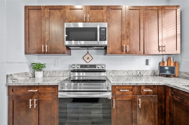 11640 SW 243rd St, Homestead, FL 33032 - kitchen with appliances with stainless steel finishes and light stone countertops