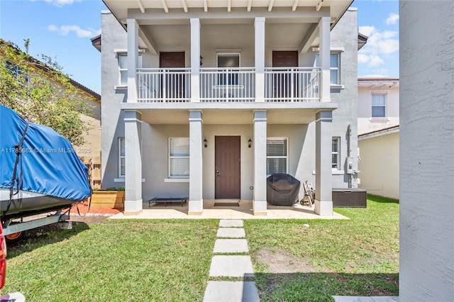 11640 SW 243rd St, Homestead, FL 33032 - view of front of house featuring a balcony, a front yard, and stucco siding