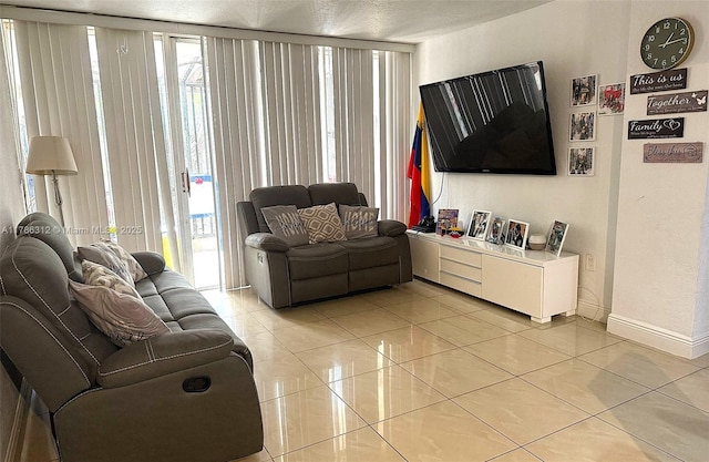 8820 Fontainebleau Blvd Unit 104, Miami, FL 33172 - living area with light tile patterned floors, baseboards, and plenty of natural light