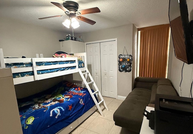 8820 Fontainebleau Blvd Unit 104, Miami, FL 33172 - bedroom with a ceiling fan, a textured ceiling, a closet, and light tile patterned flooring