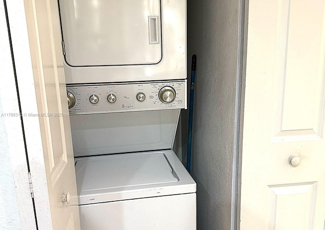 8820 Fontainebleau Blvd Unit 104, Miami, FL 33172 - laundry room featuring a textured wall, stacked washer and dryer, and laundry area