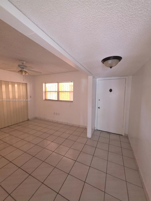 1900 W 54th St Unit 120, Hialeah, FL 33012 - interior space featuring a ceiling fan, a textured ceiling, and light tile patterned flooring