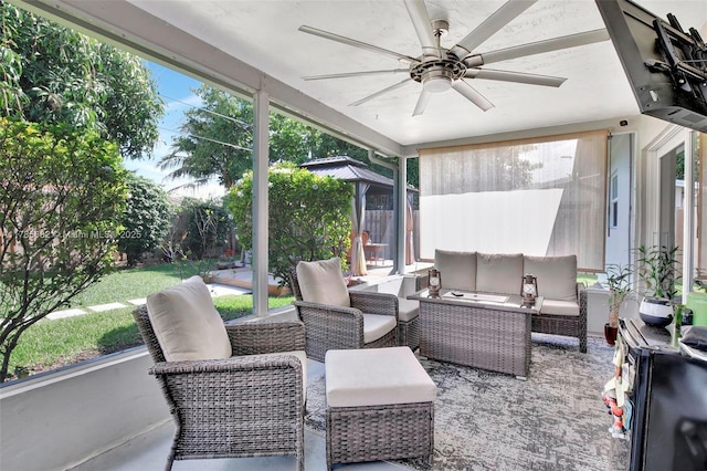 sunroom with an outdoor living space and ceiling fan