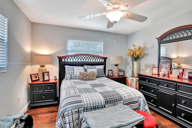 bedroom featuring ceiling fan, wood finished floors, and baseboards