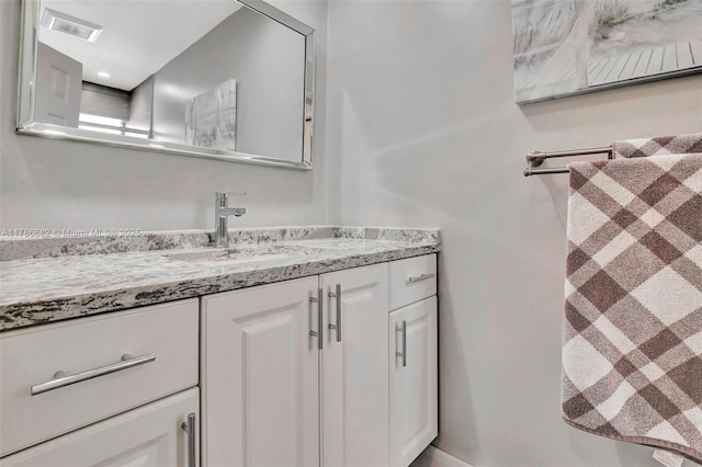 bathroom with visible vents and vanity