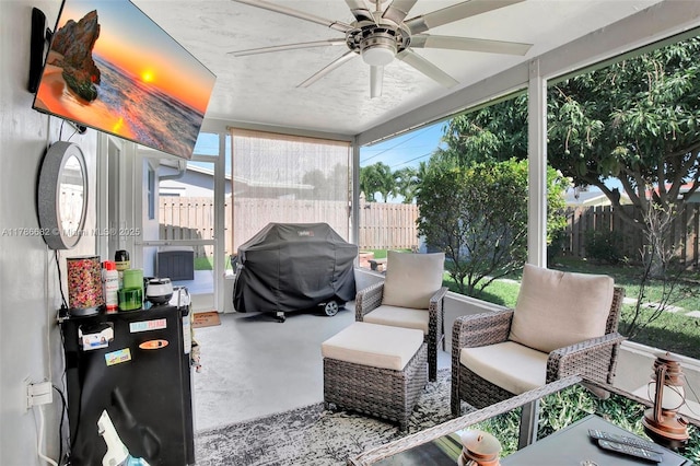sunroom featuring ceiling fan and an outdoor living space