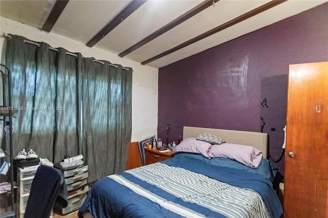 bedroom featuring vaulted ceiling with beams