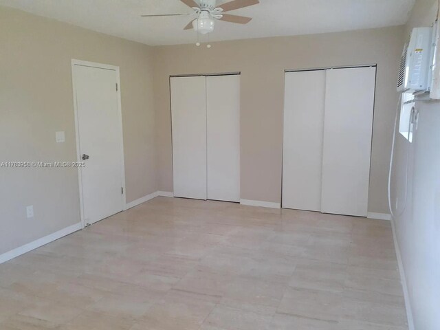 unfurnished bedroom featuring multiple closets, baseboards, and ceiling fan