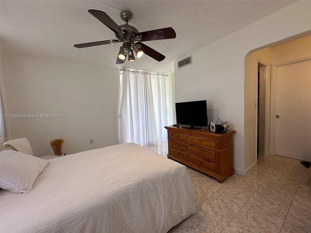 2929 Point E Dr Unit A101, Aventura, FL 33160 - bedroom featuring ceiling fan, a textured ceiling, visible vents, and light tile patterned floors
