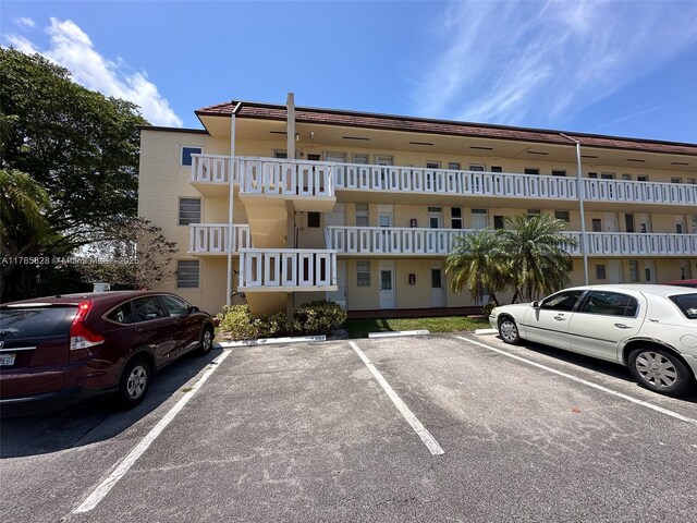 2929 Point E Dr Unit A101, Aventura, FL 33160 - view of building exterior featuring uncovered parking