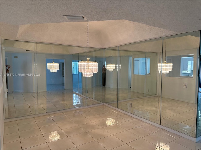 6081 SE Landing Way Unit 8, Stuart, FL 34997 - interior space with a chandelier, a textured ceiling, and baseboards