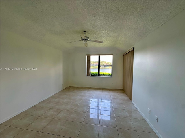 6081 SE Landing Way Unit 8, Stuart, FL 34997 - empty room featuring ceiling fan, a textured ceiling, and light tile patterned floors