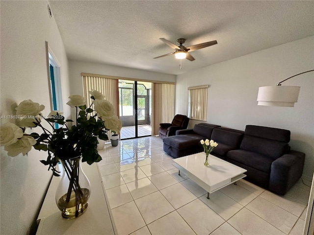 6081 SE Landing Way Unit 8, Stuart, FL 34997 - living area featuring light tile patterned flooring, a ceiling fan, and a textured ceiling
