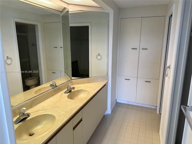 6081 SE Landing Way Unit 8, Stuart, FL 34997 - full bathroom with tile patterned floors, a closet, double vanity, and toilet