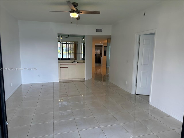 6081 SE Landing Way Unit 8, Stuart, FL 34997 - empty room featuring ceiling fan and light tile patterned flooring