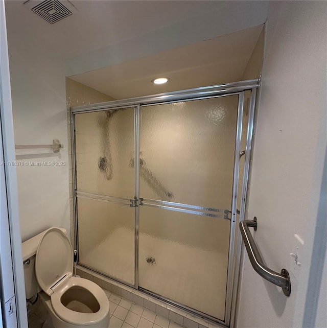 6081 SE Landing Way Unit 8, Stuart, FL 34997 - bathroom with a shower stall, toilet, and tile patterned flooring