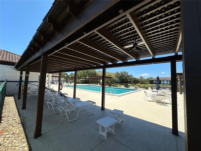 6081 SE Landing Way Unit 8, Stuart, FL 34997 - community pool featuring fence and a patio
