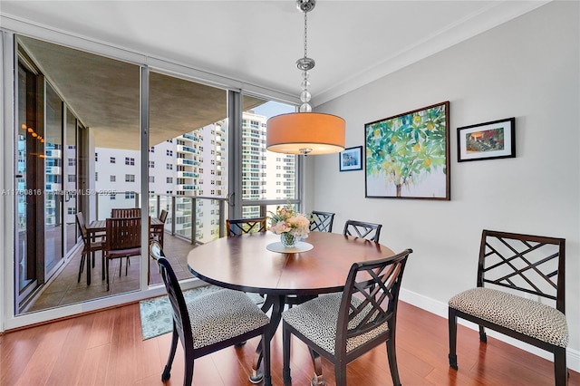 3101 S Ocean Dr Unit 701, Hollywood, FL 33019 - dining space featuring wood finished floors, baseboards, crown molding, and expansive windows