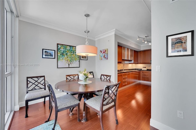 3101 S Ocean Dr Unit 701, Hollywood, FL 33019 - dining room with ornamental molding, light wood-style flooring, and baseboards
