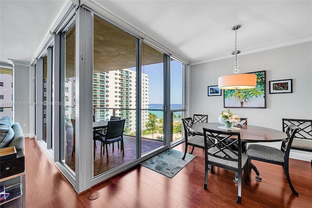 3101 S Ocean Dr Unit 701, Hollywood, FL 33019 - dining area with expansive windows, ornamental molding, wood finished floors, and a water view