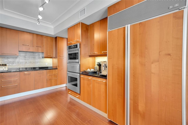 3101 S Ocean Dr Unit 701, Hollywood, FL 33019 - kitchen with paneled refrigerator, rail lighting, dark countertops, tasteful backsplash, and ornamental molding