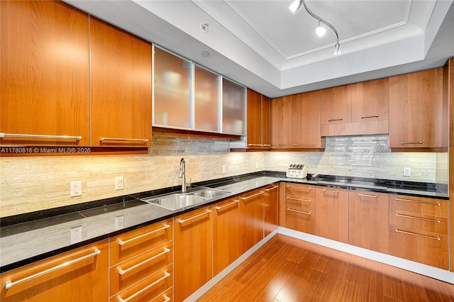 3101 S Ocean Dr Unit 701, Hollywood, FL 33019 - kitchen with a sink, wood finished floors, rail lighting, black electric stovetop, and decorative backsplash