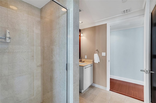 3101 S Ocean Dr Unit 701, Hollywood, FL 33019 - bathroom featuring vanity, a shower stall, tile patterned floors, ornamental molding, and baseboards