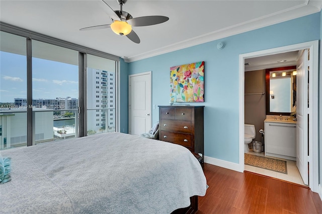 3101 S Ocean Dr Unit 701, Hollywood, FL 33019 - bedroom with wood finished floors, ornamental molding, baseboards, ensuite bathroom, and a sink