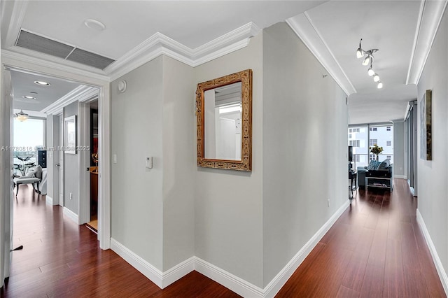 3101 S Ocean Dr Unit 701, Hollywood, FL 33019 - hallway featuring dark wood-style flooring, ornamental molding, baseboards, and rail lighting