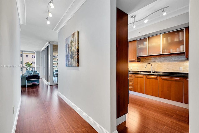 3101 S Ocean Dr Unit 701, Hollywood, FL 33019 - hallway featuring track lighting, a sink, wood finished floors, and baseboards