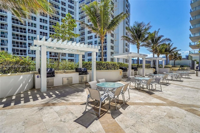 3101 S Ocean Dr Unit 701, Hollywood, FL 33019 - view of patio / terrace with a pergola, outdoor dining space, and a sink
