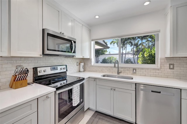 2506 NE 30th St, Fort Lauderdale, FL 33306 - kitchen with appliances with stainless steel finishes, a sink, light countertops, decorative backsplash, and recessed lighting