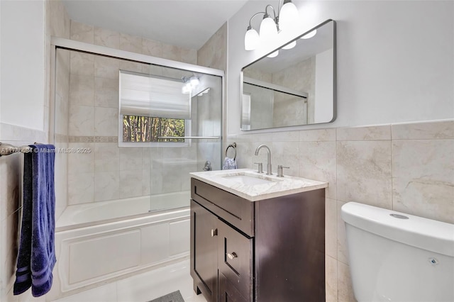 2506 NE 30th St, Fort Lauderdale, FL 33306 - full bathroom with vanity, tile walls, bath / shower combo with glass door, and toilet