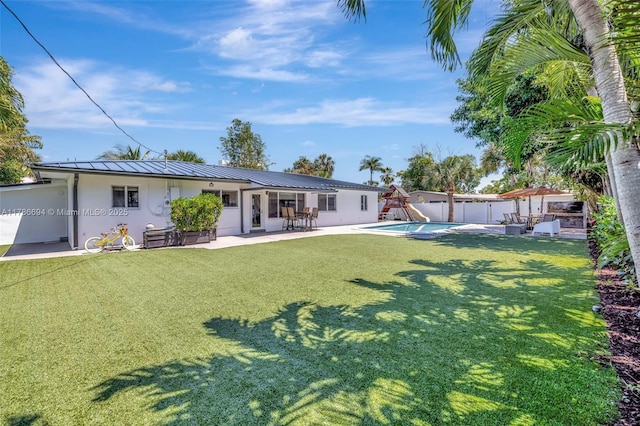 2506 NE 30th St, Fort Lauderdale, FL 33306 - back of house with stucco siding, a patio area, metal roof, and a standing seam roof