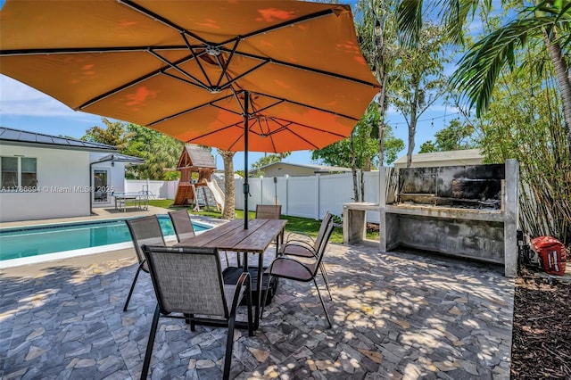 2506 NE 30th St, Fort Lauderdale, FL 33306 - fenced backyard with a playground, a patio area, and outdoor dining space