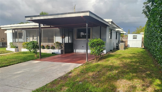 521 N 70th Way, Hollywood, FL 33024 - view of front of home with an attached carport, brick siding, and concrete driveway