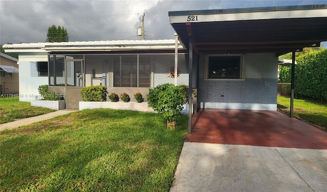 521 N 70th Way, Hollywood, FL 33024 - view of front facade featuring a front lawn, an attached carport, and brick siding