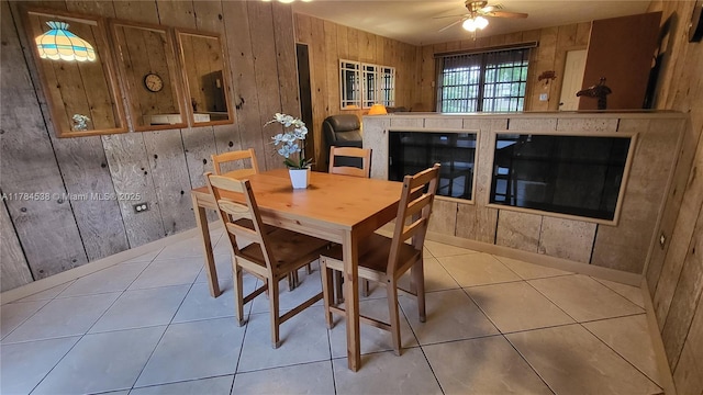 521 N 70th Way, Hollywood, FL 33024 - dining room featuring a ceiling fan, wood walls, and tile patterned floors