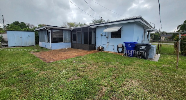 521 N 70th Way, Hollywood, FL 33024 - back of property with a sunroom, a storage unit, an outbuilding, and a gate