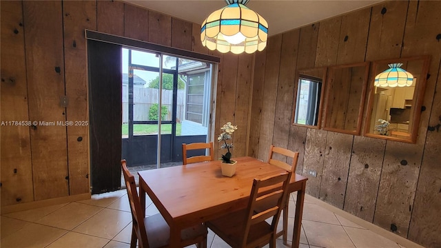 521 N 70th Way, Hollywood, FL 33024 - dining area featuring light tile patterned floors and wood walls
