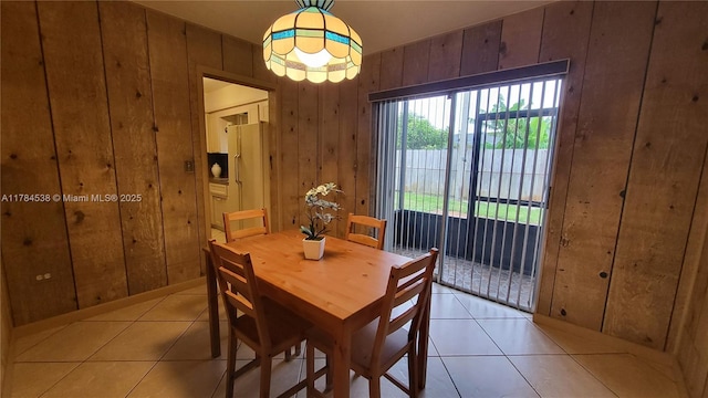 521 N 70th Way, Hollywood, FL 33024 - dining room with light tile patterned floors and wood walls